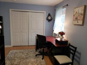 a office with a desk and a chair and a door at Fantastic Poconos home w/ Fireplace + More!!! in Long Pond