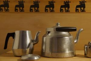 a tea kettle and a cup on a table at Riad Honey in Marrakesh