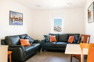 a living room with two couches and a couch at Apartments Delic in Ražanac