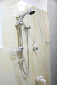 a shower with a shower head in a bathroom at Ranathisara Grand Cabanas in Kurunegala