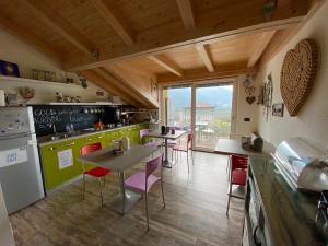 a kitchen with a table and chairs in a kitchen at B&B A.R.C.O. in Arco