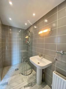 a bathroom with a sink and a shower at The Coach House at Moyglare Manor in Maynooth