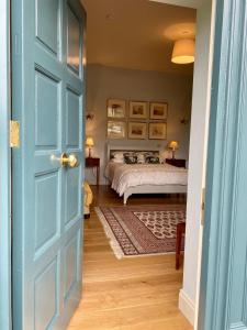 a bedroom with a bed and a blue door at The Coach House at Moyglare Manor in Maynooth