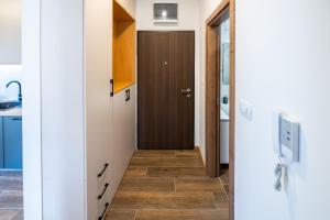 a hallway with a door and a tile floor at LuMi Kolasin in Kolašin +14 photos
