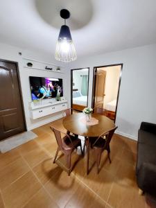 a living room with a table and a tv at Steff's Condo 2622 at One Oasis in Cagayan de Oro