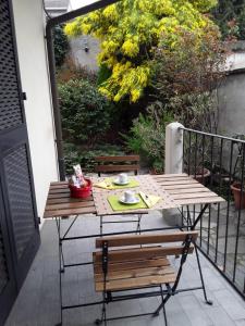 a wooden table and bench on a balcony at Mimosa House in Turin