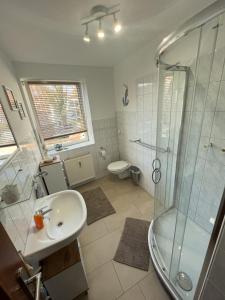 a bathroom with a sink and a shower at Ferienwohnung Just Home in Wismar