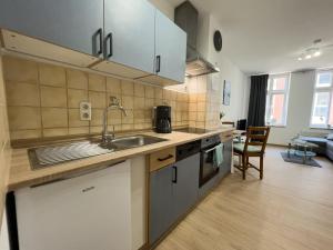 a kitchen with a sink and a counter top at Ferienwohnung Just Home in Wismar