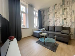 a living room with a couch and a table at Ferienwohnung Just Home in Wismar