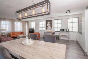 a dining room and living room with a table and chairs at Heuvel zicht in Oss