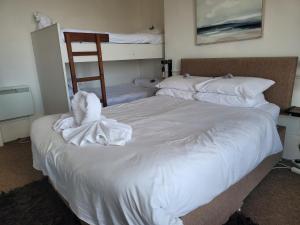 a bedroom with two beds with towels on them at Sea View flat 2 with Fast WiFi and FREE parking in Scarborough