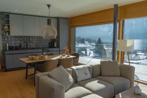 a living room with a couch and a table and a kitchen at sunrise2sunset in Arosa +3 photos