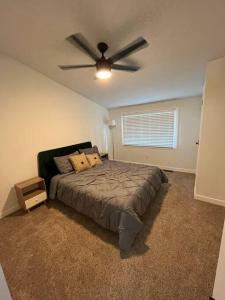 a bedroom with a bed with a ceiling fan at Luxury 2BR within walking distance to Nightlife!! in Covington