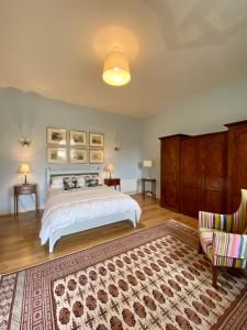 a bedroom with a white bed and a rug at The Coach House at Moyglare Manor in Maynooth