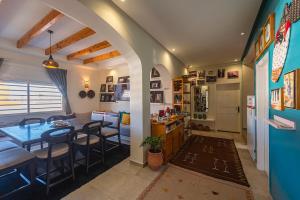 a kitchen and dining room with a table and chairs at Kite House Dakhla in Dakhla
