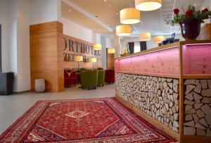 a hotel lobby with a red rug on the floor at Sporthotel Zederhaus im Lungau in Zederhaus