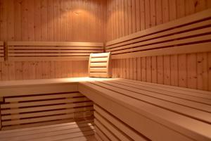 a sauna with wooden benches and a light in it at Sporthotel Zederhaus im Lungau in Zederhaus