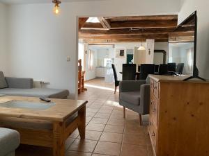 uma sala de estar com um sofá e uma mesa em Cottage - Artland's Home - Landhaus für Familien und Gruppen em Badbergen
