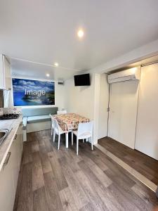 a kitchen and dining room with a table and chairs at Camping Village La Sorgente in Portoferraio