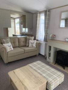 a living room with a couch and a fireplace at Grasmere Lodge Unit 31 in Carlisle