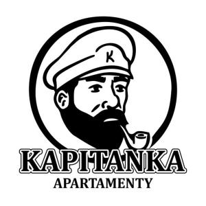 a man in a cap with a pipe in his mouth at Kapitanka Apartamenty in Okuninka