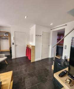 a living room with a couch and a television at Duplex cosy Life Balnéo in Cysoing +10 photos