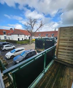a balcony with cars parked in a parking lot at Duplex cosy Life Balnéo in Cysoing
