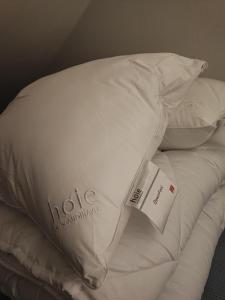 a stack of white pillows on top of a bed at Leviraitti 4 A2 in Kittilä