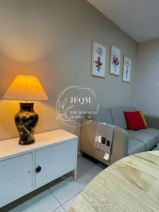 a bedroom with a couch and a lamp on a dresser at Liberty ARC - Greenary & Warmest (Wifi) (2-3pax) in Ampang