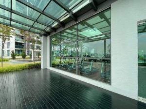 a glass building with a reflection of a table in the window at Liberty ARC - Greenary & Warmest (Wifi) (2-3pax) in Ampang