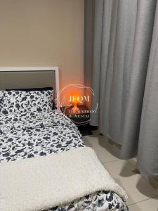 a bedroom with a bed and a window with curtains at Liberty ARC - Greenary & Warmest (Wifi) (2-3pax) in Ampang