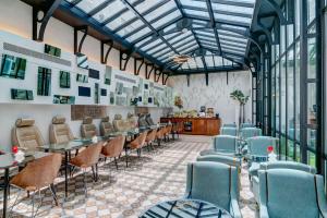 a restaurant with chairs and tables and windows at Hotel Joyce - Astotel in Paris