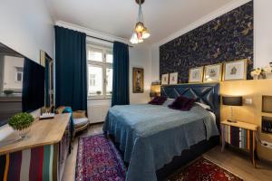 a bedroom with a blue bed and a desk at 3on7 Apartments in Zagreb