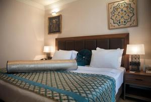 a hotel room with a bed with a large headboard at Golden Age Hotel Taksim in Istanbul