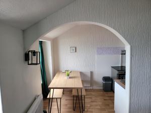 a kitchen with a wooden table in a room at Sea view Penthouse flat 6 with fast WiFi and Free PARKING in Scarborough