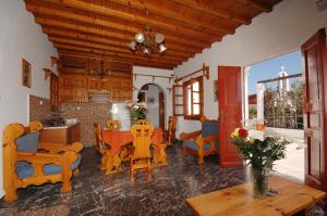 a kitchen and living room with a table and chairs at Villa Vasilis in Mikonos
