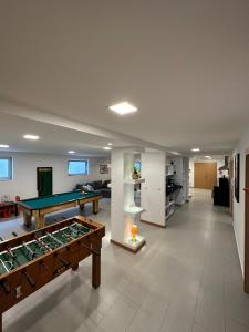 a large living room with a pool table in it at Santiago 2 in Castelo do Neiva