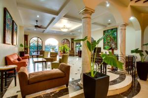 a lobby with chairs and tables and plants at San Ignacio Resort Hotel in San Ignacio