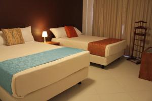 A bed or beds in a room at Hotel Casa Sakiwa