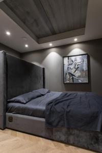 a bedroom with a bed with a gray bed frame at HOUSE38 Panoramic View Apartments SELF CHECK-IN in Kaunas