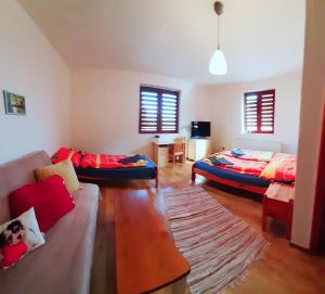 a living room with two beds and a couch at Relax Mariánka in Betlanovce