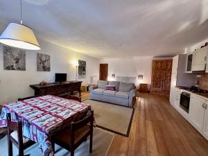 a living room with a couch and a table at La Baita di BessenHaut 