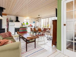 a living room with a couch and a table at 5 person holiday home in Faxe Ladeplads in Fakse Ladeplads