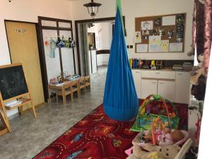 a living room with a blue umbrella and a kitchen at Penzion Pod Hamižnou in Hartmanice