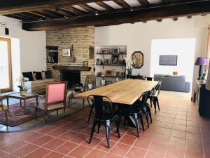 a living room with a large wooden table and chairs at Maison Céleste in Nuits-Saint-Georges