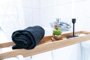 a bathroom shelf with a towel and a sink at Apartment Wesseling in Wesseling
