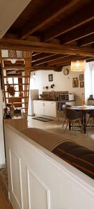 a living room with a table and a kitchen at gite du pré in Gorron