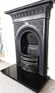 an old black fireplace in a room at Britannia House Vintage B&B Cornwall in Helston