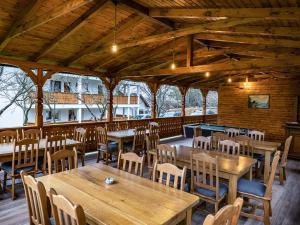 a dining room with wooden tables and chairs at Drag de Maramureș in Ocna Şugatag