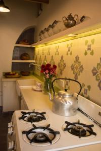 a kitchen with a stove with a tea kettle on it at Cielo Arriba Casa in Humahuaca